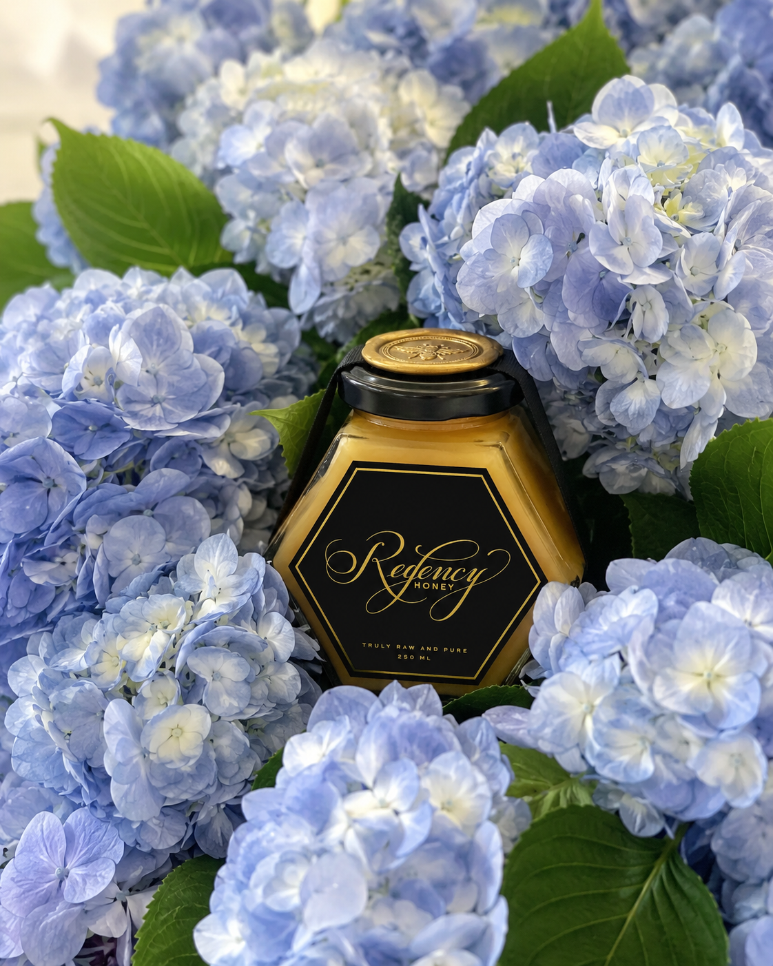 Regency Honey jar nestled in blue hydrangeas